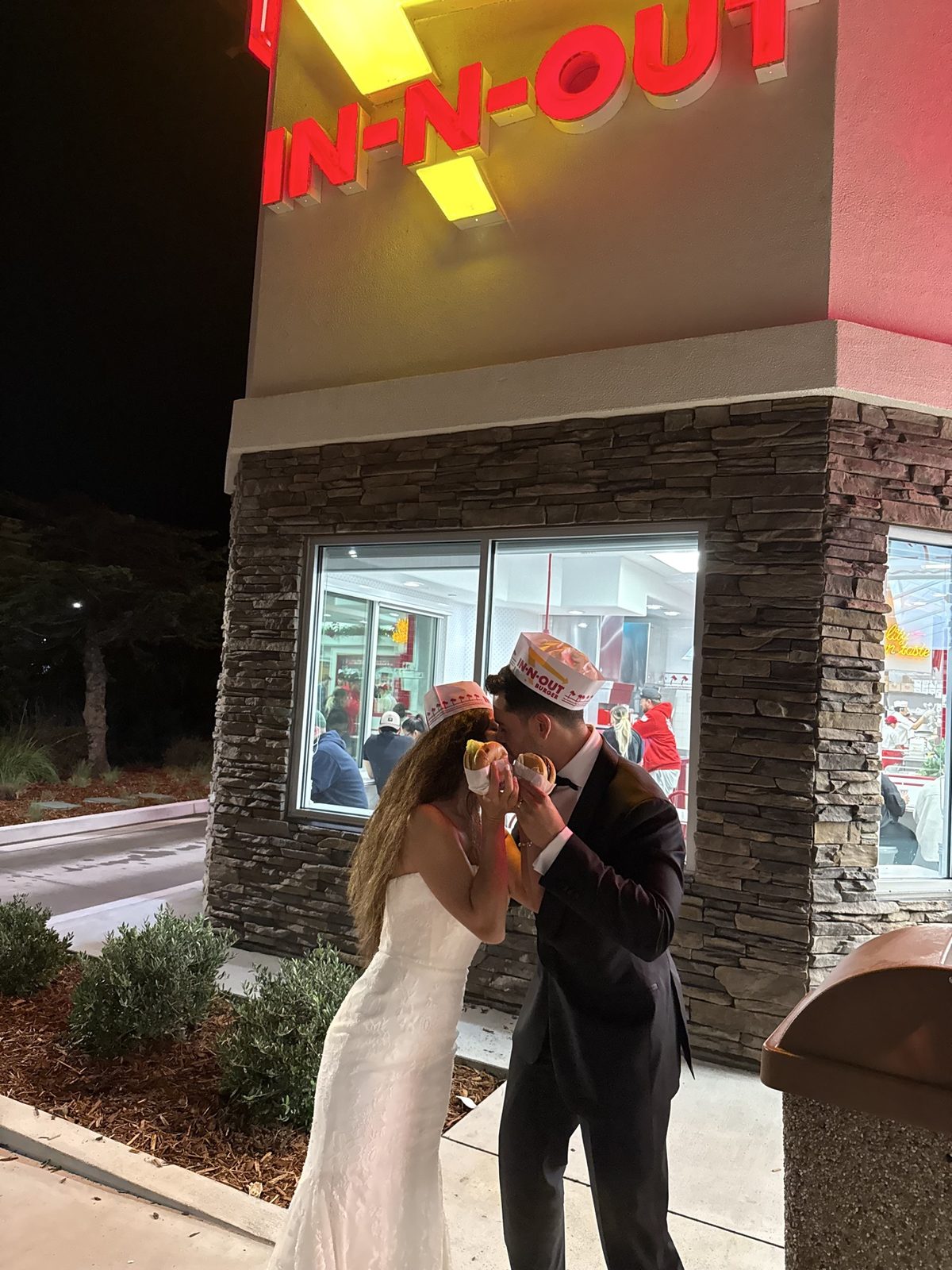 Ruben and Janeza sharing burgers after their wedding